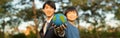 Focus Earth with blurred asian boy and businessman holding globe together. Gyre