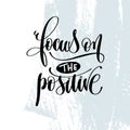 Focus on the positive - hand lettering inscription on blue brush