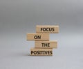 Focus on the Positives symbol. Concept word Focus on the Positives on wooden blocks. Beautiful grey background. Business and Focus Royalty Free Stock Photo
