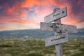 focus on possibilities text engraved in wooden signpost outdoors in nature during sunset