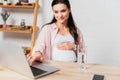 Focus of pregnant woman using laptop Royalty Free Stock Photo