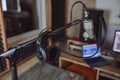 Focus on professional microphone and headphones in the blurred soud engineer workplace Royalty Free Stock Photo