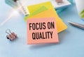 FOCUS ON QUALITY text on notepad on office table