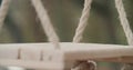 Focus rack close up of an empty swing in the middle of a desolate park in an autumn day. slow motion