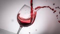 Focus on realistic glass with falling red wine on white background , generated by AI Royalty Free Stock Photo
