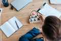 Focus of recruiter holding magnifying glass near wooden cubes