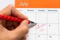 Focus on the red pen marking on the calendar for 4th of July as