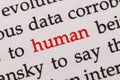 Focus on the red word human. Macro shot printed red colour word Human on a piece of paper or book Royalty Free Stock Photo