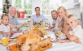 Focus on the roast turkey in front of family Royalty Free Stock Photo