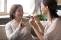 Elderly mother and adult daughter communicating using sign language Royalty Free Stock Photo