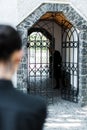 Focus of sad senior man standing in building near woman in cemetery Royalty Free Stock Photo