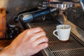 Picture Focus selection: Coffee flows from a professional coffee maker with a deep filter on a white cup