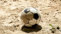 Focus at Single Ball on the beach with nobody. Broken classic ball on the sand.