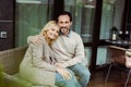 Focus of smiling man hugging wife Royalty Free Stock Photo