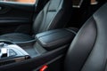 Focus on storage compartments of central console between front seats of luxurious automobile. Resting place for Royalty Free Stock Photo