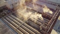 Focus on toxic fumes spread from the roof of an industrial plant. Industrial plants emit large amounts of white smoke from the fac