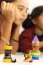 Focus on Toys, Cute little child girl playing with Indian wooden channapatna toys at home Royalty Free Stock Photo