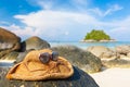 Focus on Weave hat and sunglasses on rock white sand beach. - Yo Royalty Free Stock Photo