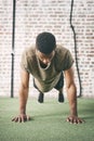 Focus on what must be done and dont stop until its done. a sporty young man doing pushups at the gym. Royalty Free Stock Photo