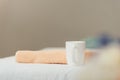Focus of white cup and beige towel in spa Royalty Free Stock Photo