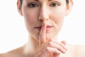 Focus on woman with her finger on mouth Royalty Free Stock Photo