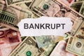 Focus on the word BANKRUPT on piece of torn white paper with blu