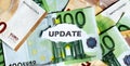 Focus on the word UPDATE , on piece of torn white paper with EUROS currency as a background Royalty Free Stock Photo