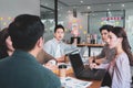 Focus on young asian man having question in group brainstorm meeting in office.Businesspeople discussing with paperwork for Royalty Free Stock Photo