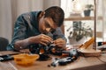 Focus is your biggest ally in this field. a handsome young boy building a robotic toy car at home.