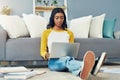 Focused on acing her finals. a young female student studying at home.