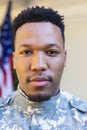 Focused african american male soldier face close up outside home with usa flag, copy space