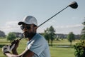 Focused african american man playing golf at golf course Royalty Free Stock Photo