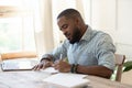 Focused african man student freelancer making notes studying with laptop Royalty Free Stock Photo