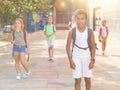 African american preteen boy with backpack walking outdoors
