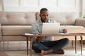 Focused african man studying or working on laptop at home Royalty Free Stock Photo