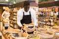 Salesman arranging showcase with bulk foods