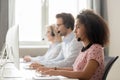 Focused african call center operator consulting customer looking at computer Royalty Free Stock Photo