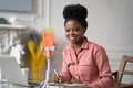 Focused Afro-American millennial woman remote studying, working online on laptop, chatting with friends via video call on Royalty Free Stock Photo