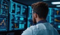 A focused analyst reviews complex data on multiple screens in a modern tech environment, highlighting the world of data analytics