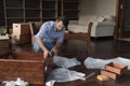 Focused apartment buyer man assembling furniture in new apartment Royalty Free Stock Photo