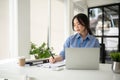 A focused Asian businesswoman is signing documents and working on her business work Royalty Free Stock Photo