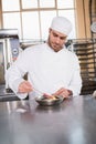 Focused baker preparing a pastry