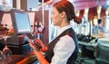 Focused barmaid using touchscreen till Royalty Free Stock Photo