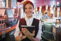 Focused barmaid using touchscreen till Royalty Free Stock Photo