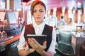 Focused barmaid using touchscreen till Royalty Free Stock Photo