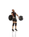 Focused bearded man, athlete with strong body training, lifting heavy weights, barbell against white background Royalty Free Stock Photo