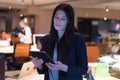 Focused beautiful  young businesswoman using a digital tablet while has a live meeting via social network together with her Royalty Free Stock Photo