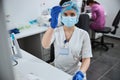 Focused biochemist holding a vacutainer at the lab table