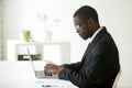 Focused black worker working at laptop at company workplace Royalty Free Stock Photo