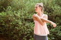 Focused blonde athlete stretching arms